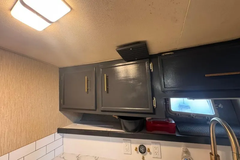 Slide: The Image of Interior of 1982 Sunliner Ocean Yachts with dark cabinets and modern lighting. - 40