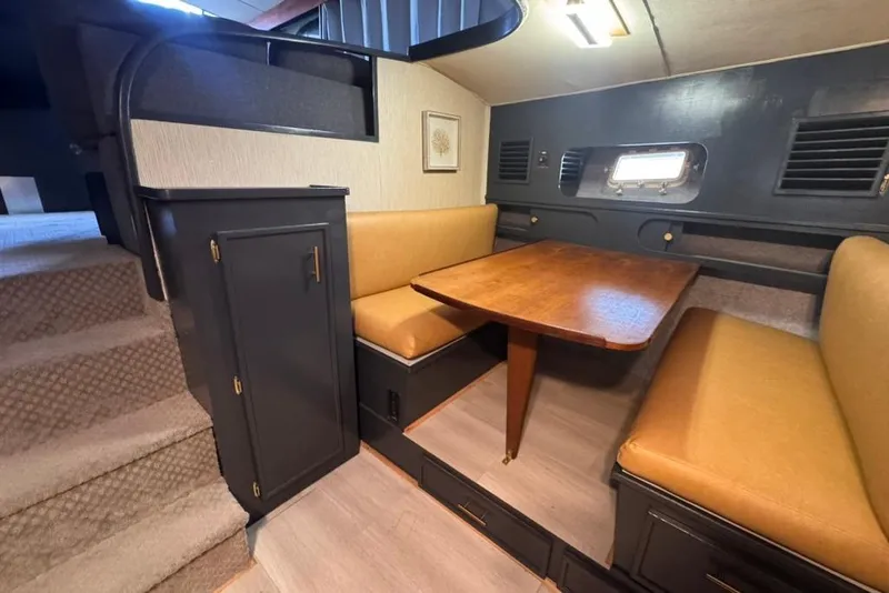 Slide: The Image of Interior of 1982 Sunliner Ocean Yachts with cozy dining area and wooden table. - 41