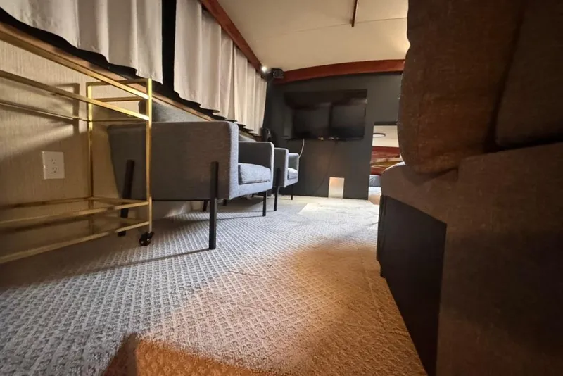 Slide: The Image of Interior of 1982 Sunliner Ocean Yachts with modern seating and carpeted flooring. - 46