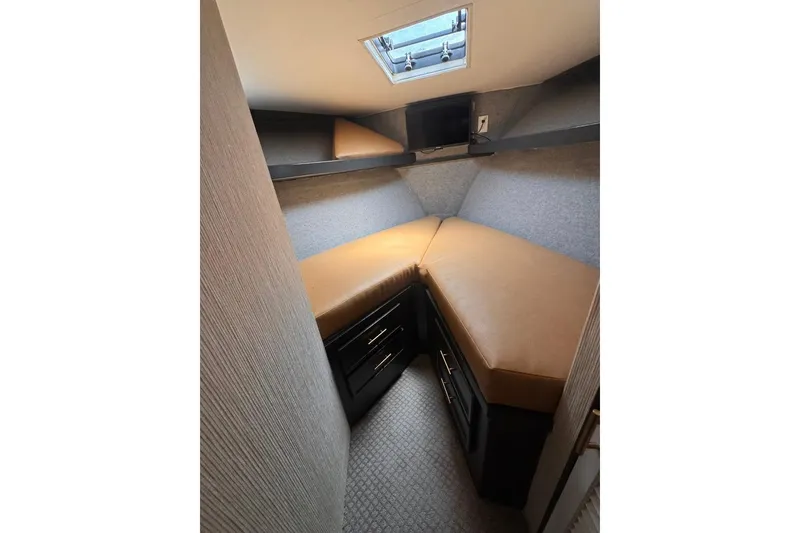 Slide: The Image of Cozy cabin interior of 1982 Sunliner Ocean Yachts with tan cushions and storage drawers. - 49