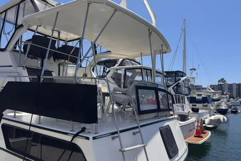 Slide: The Image of 1982 Sunliner Ocean Yachts docked in a marina under clear blue skies. - 5
