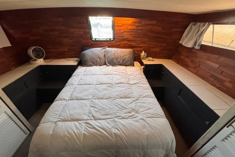 Slide: The Image of Cozy bedroom in 1982 Sunliner Ocean Yachts with wood paneling and a comfortable bed. - 51
