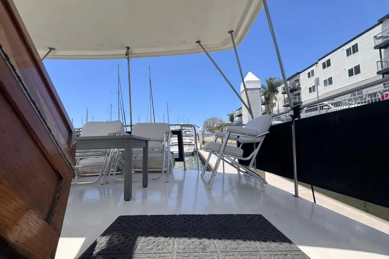 Slide: The Image of 1982 Sunliner Ocean Yachts deck with chairs and table, docked at marina. - 8