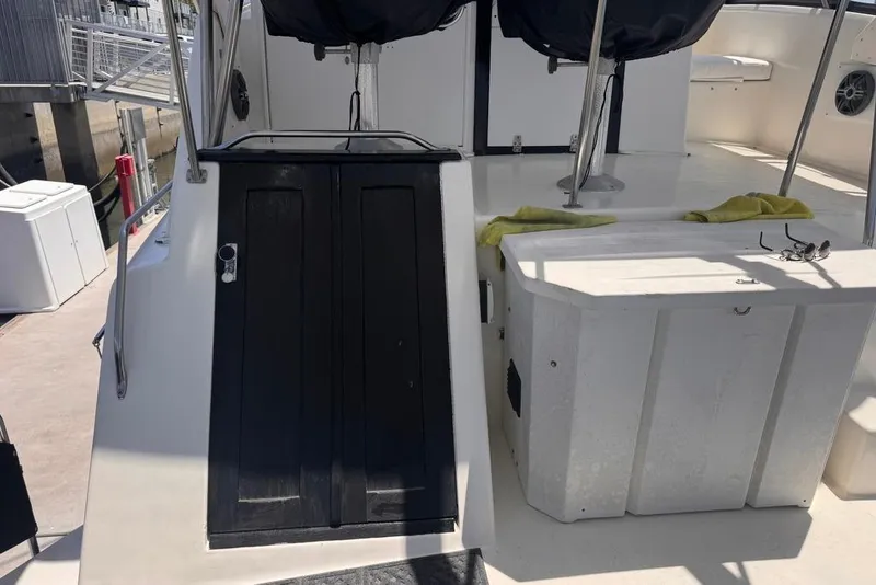 Slide: The Image of 1982 Sunliner Ocean Yachts deck with black doors and white seating area. - 9