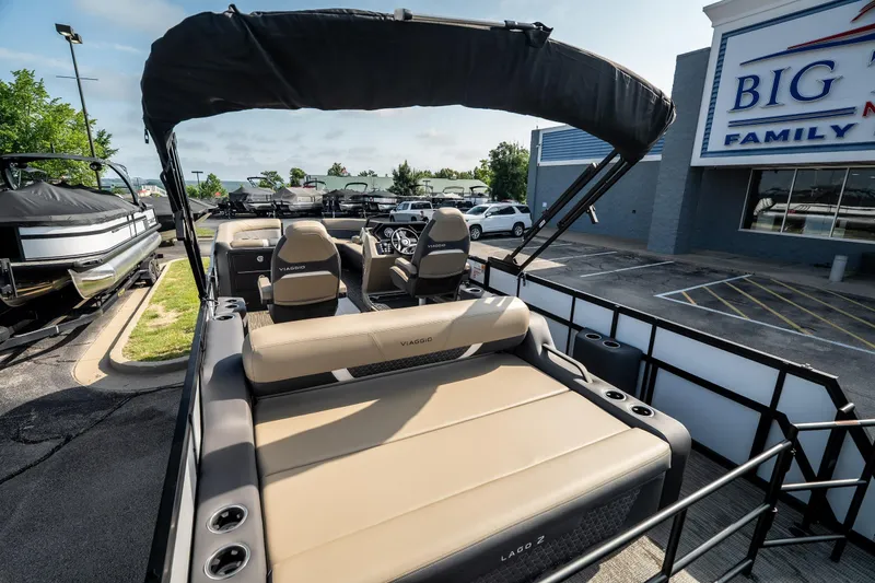 Slide: The Image of 2026 Viaggio Z24S pontoon boat with beige seating, parked at dealership. - 34