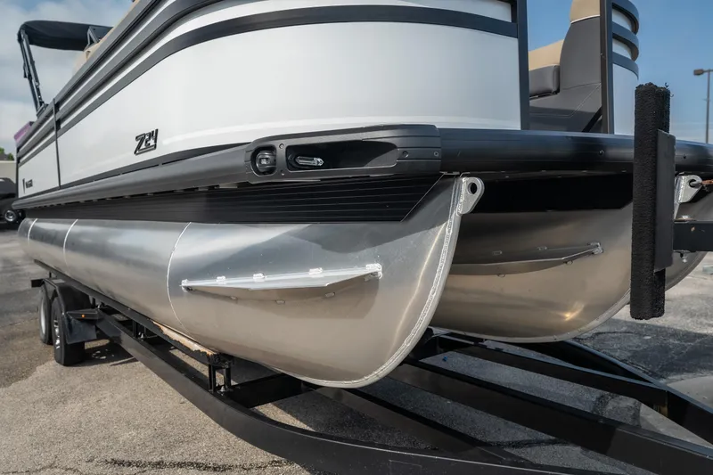 Slide: The Image of 2026 Viaggio Z24S pontoon boat on trailer, showcasing sleek aluminum pontoons and modern design. - 4