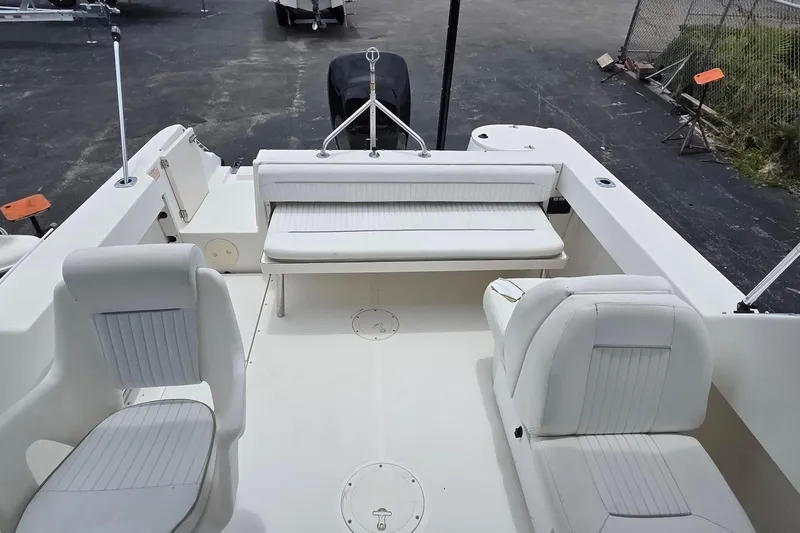 Slide: The Image of 2000 Boston Whaler 21 Ventura boat interior with white seating and spacious deck layout. - 11