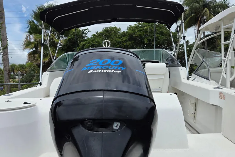 Slide: The Image of 2000 Boston Whaler 21 Ventura boat with Mercury 200 SaltWater engine, under canopy. - 6