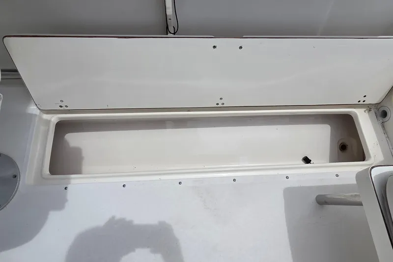 Slide: The Image of Open storage compartment on a 2000 Boston Whaler 21 Ventura boat. - 15