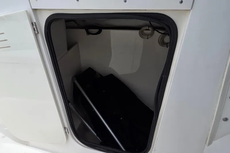 Slide: The Image of Storage compartment of a 2000 Boston Whaler 21 Ventura boat, partially open. - 14
