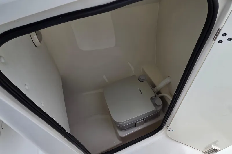 Slide: The Image of Portable toilet inside 2000 Boston Whaler 21 Ventura boat compartment. - 13