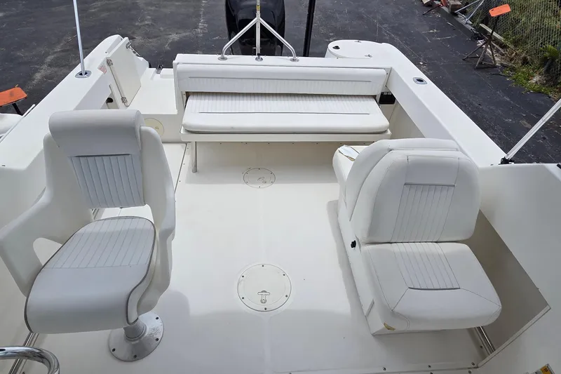 Slide: The Image of Interior of a 2000 Boston Whaler 21 Ventura boat with white seating and clean deck. - 12