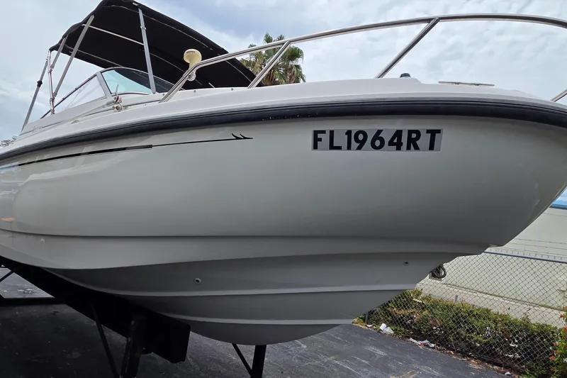 Slide: The Image of 2000 Boston Whaler 21 Ventura boat with registration FL1964RT, docked outdoors. - 4