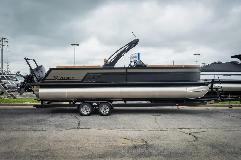 The Image of 2026 Viaggio Diamante UWA 26 pontoon boat on trailer, parked outdoors. - 1
