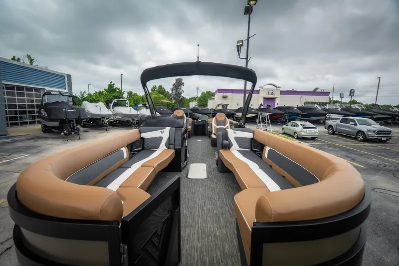 Slide: The Image of Luxurious 2026 Viaggio Diamante UWA 26 pontoon boat with spacious seating in a dealership lot. - 16