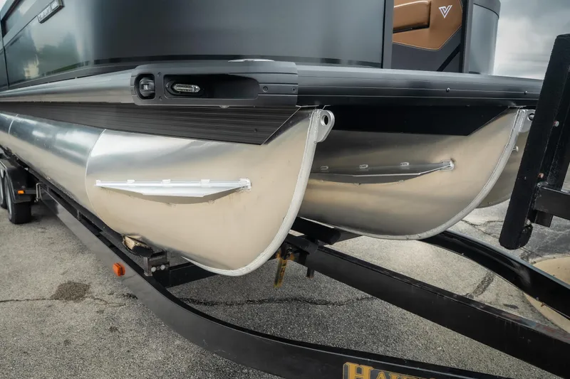Slide: The Image of 2026 Viaggio Diamante UWA 26 pontoon boat on trailer, showcasing sleek aluminum pontoons. - 4