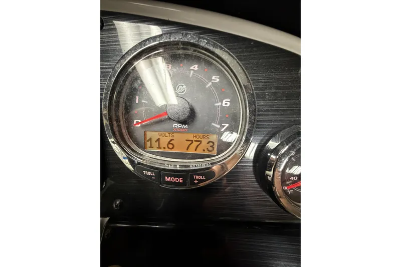 Slide: The Image of Close-up of 2022 Starcraft Star Step 221 I/O boat tachometer displaying RPM, volts, and hours. - 3