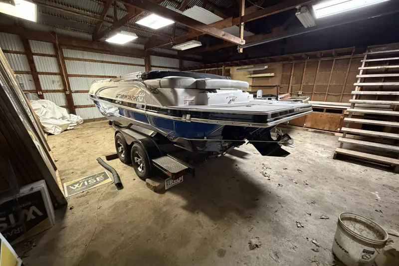 Slide: The Image of 2022 Starcraft Star Step 221 I/O boat in a wooden garage. - 6