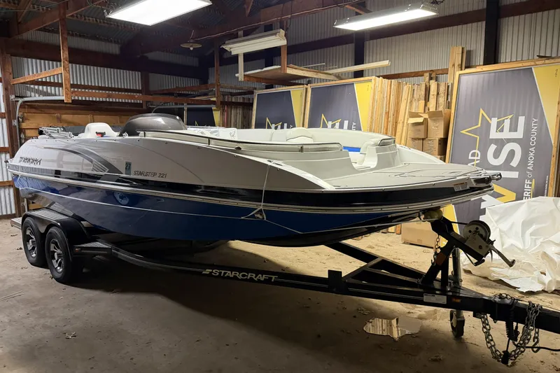 The Image of 2022 Starcraft Star Step 221 I/O boat on trailer in a storage facility. - 1