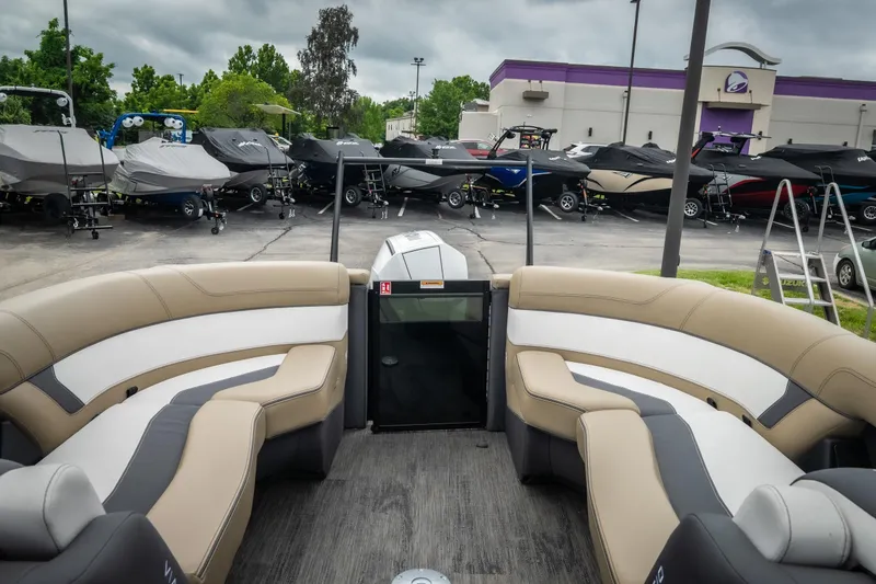 Slide: The Image of Interior view of 2026 Viaggio D26U boat with beige seating, parked among covered boats. - 20
