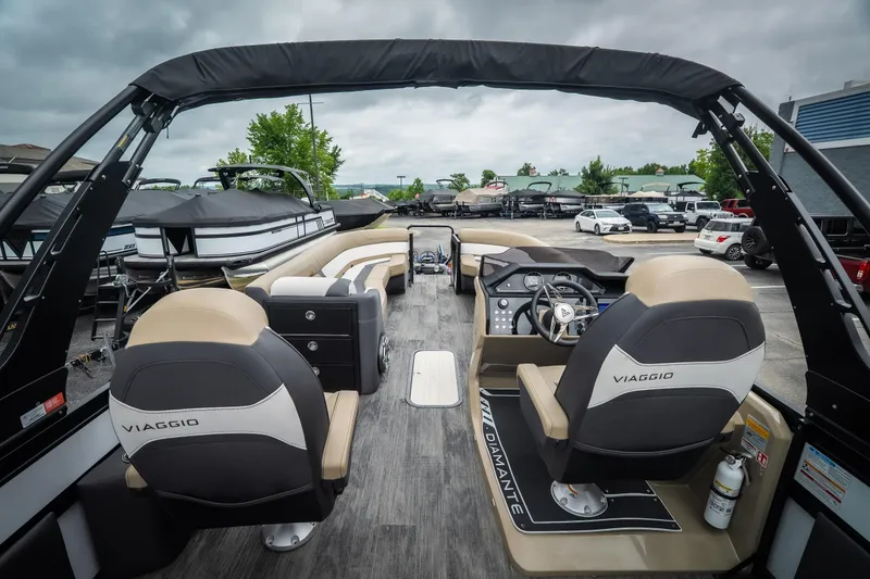 Slide: The Image of 2026 Viaggio D26U boat interior with modern dashboard and seating, parked at a marina. - 21