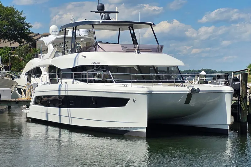 The Image of 2018 Fountaine Pajot Motor Yacht 44 docked in a marina under a blue sky. - 0