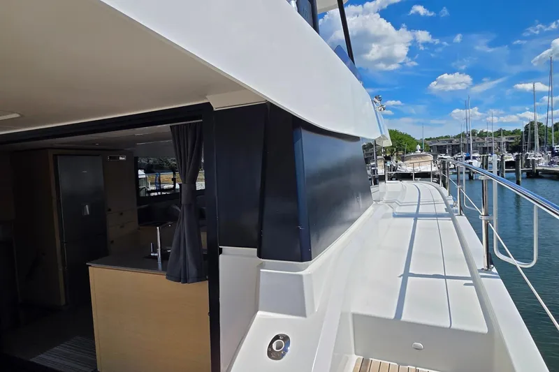 Slide: The Image of 2018 Fountaine Pajot Motor Yacht 44, featuring sleek design and spacious deck, docked at marina. - 11