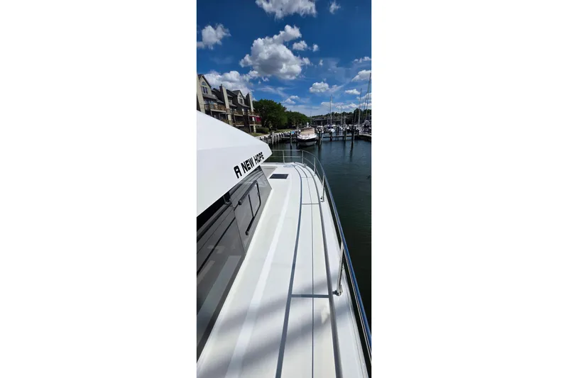 Slide: The Image of 2018 Fountaine Pajot Motor Yacht 44 docked in a marina under a clear blue sky. - 12