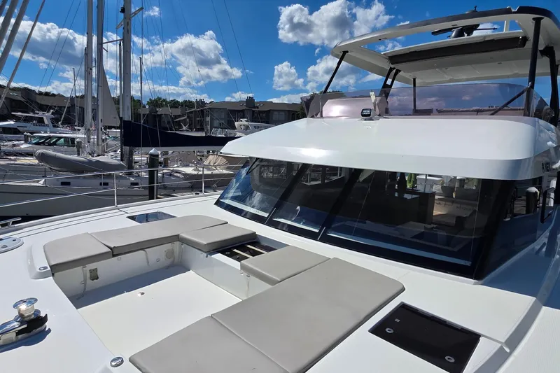Slide: The Image of 2018 Fountaine Pajot Motor Yacht 44 docked, showcasing sleek design and spacious deck seating. - 16