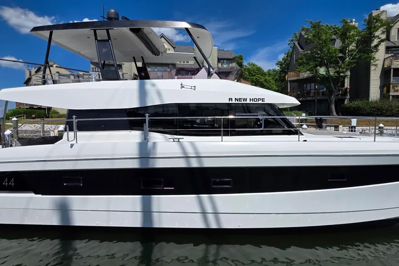 Slide: The Image of 2018 Fountaine Pajot Motor Yacht 44 docked, named "A New Hope," with modern design. - 2