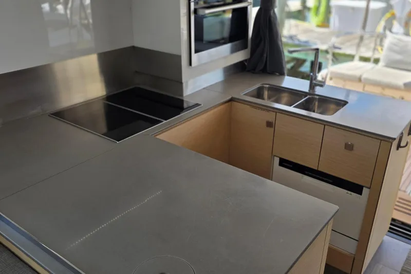 Slide: The Image of Modern kitchen in 2018 Fountaine Pajot Motor Yacht 44 with sleek countertops and appliances. - 24