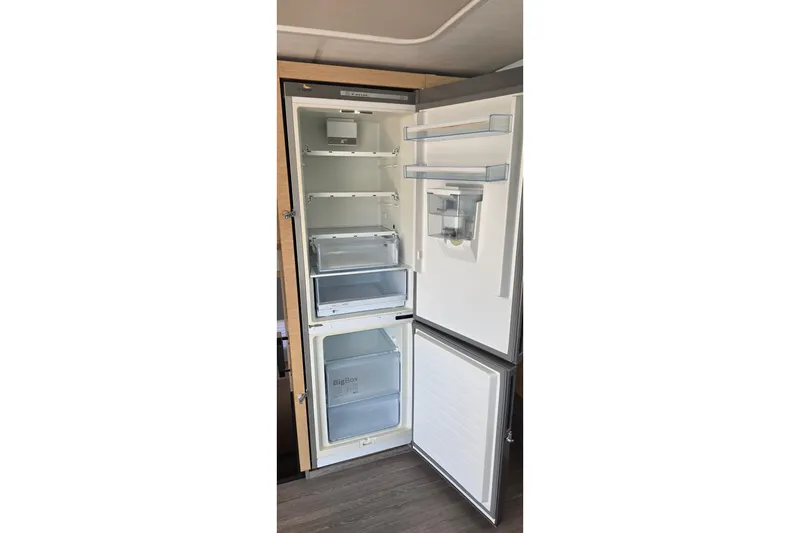 Slide: The Image of Open refrigerator inside 2018 Fountaine Pajot Motor Yacht 44, showcasing spacious interior and storage compartments. - 26