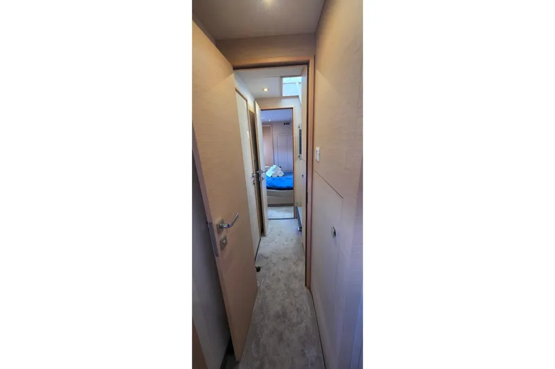 Slide: The Image of Hallway view inside 2018 Fountaine Pajot Motor Yacht 44, leading to a cozy cabin. - 47
