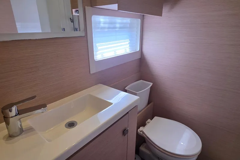 Slide: The Image of Modern bathroom in 2018 Fountaine Pajot Motor Yacht 44, featuring sleek sink and toilet. - 53