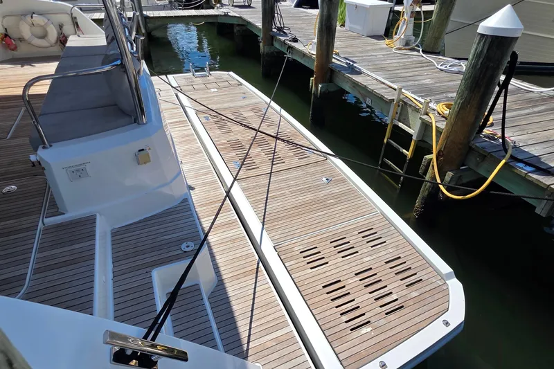 Slide: The Image of Fountaine Pajot Motor Yacht 44, 2018 model, docked with wooden deck and seating area. - 6
