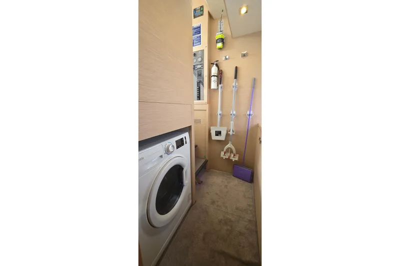 Slide: The Image of Laundry area on 2018 Fountaine Pajot Motor Yacht 44 with washer and cleaning tools. - 60