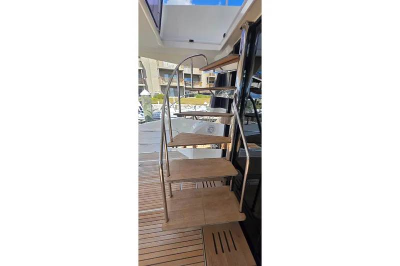 Slide: The Image of Staircase on 2018 Fountaine Pajot Motor Yacht 44 with wooden steps and metal railing. - 69