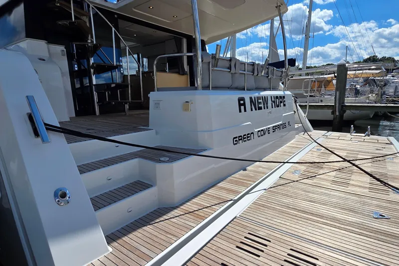 Slide: The Image of Fountaine Pajot Motor Yacht 44, 2018, docked with wooden deck and stairs. - 7