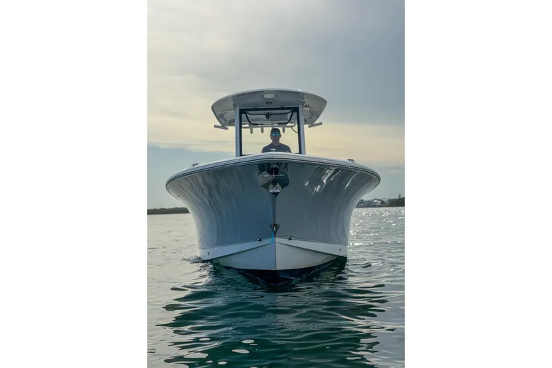 Slide: The Image of 2024 Sea Hunt Gamefish 27 boat on calm water, front view. - 11