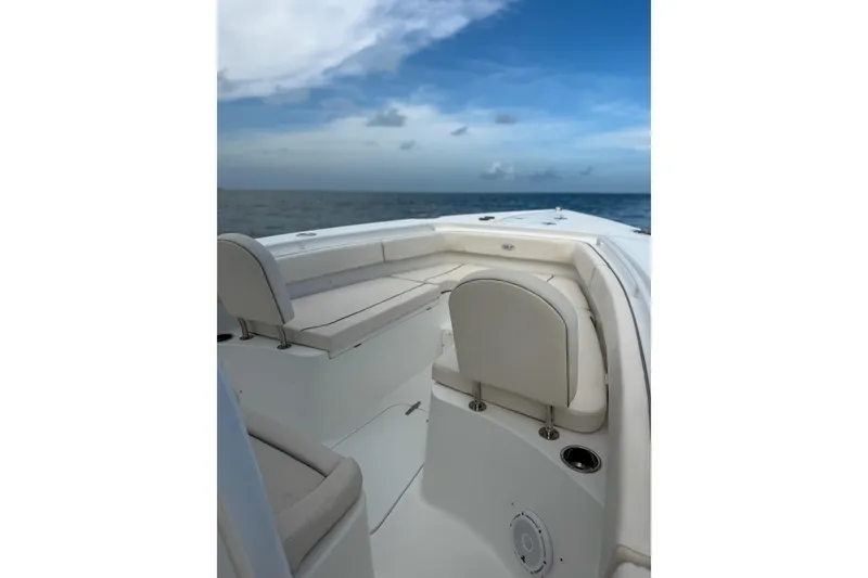 Slide: The Image of 2024 Sea Hunt Gamefish 27 Forward Seating boat with ocean view and clear sky. - 14