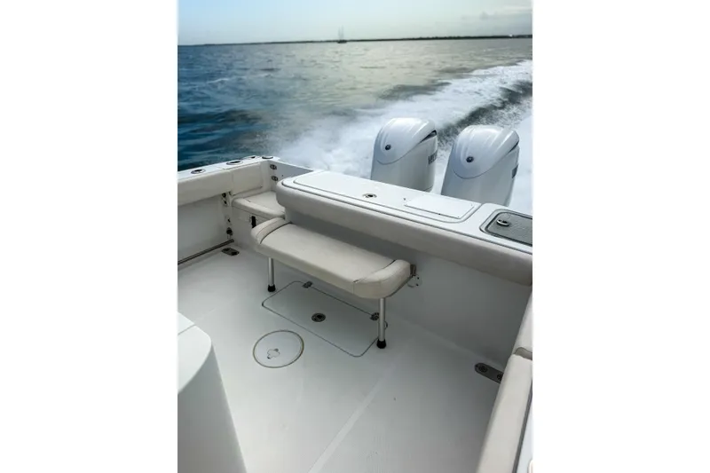 Slide: The Image of 2024 Sea Hunt Gamefish 27 boat with forward seating, dual engines, cruising on open water. - 16