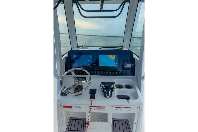 Slide: The Image of 2024 Sea Hunt Gamefish 27 helm with advanced navigation and control systems. - 18