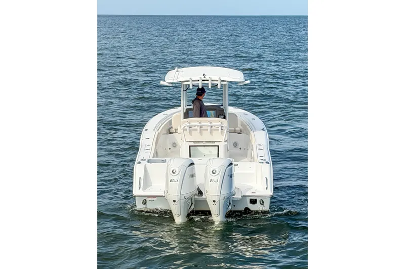 Slide: The Image of 2024 Sea Hunt Gamefish 27 boat with dual engines on open water. - 2