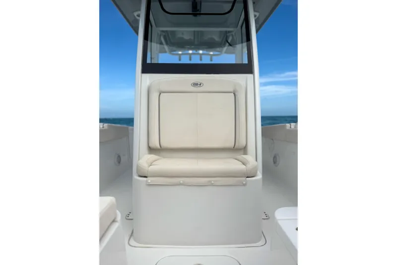 Slide: The Image of 2024 Sea Hunt Gamefish 27 Forward Seating, featuring comfortable beige seating against a blue ocean backdrop. - 25