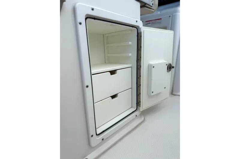 Slide: The Image of Storage compartment with drawers on 2024 Sea Hunt Gamefish 27 Forward Seating boat. - 26
