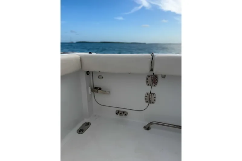 Slide: The Image of 2024 Sea Hunt Gamefish 27 boat interior with ocean view, showcasing seating and hardware. - 29