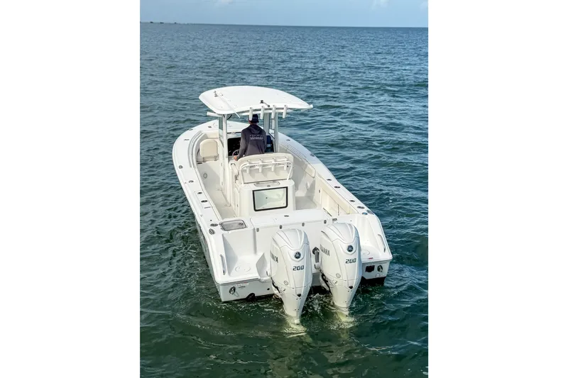 Slide: The Image of 2024 Sea Hunt Gamefish 27 boat with dual engines on open water. - 3
