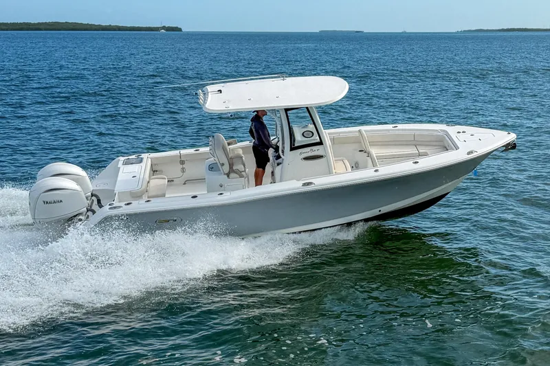 Slide: The Image of 2024 Sea Hunt Gamefish 27 Forward Seating boat cruising on open water. - 5
