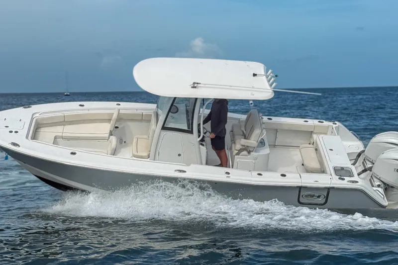 Slide: The Image of 2024 Sea Hunt Gamefish 27 boat cruising on open water, featuring forward seating and sleek design. - 7