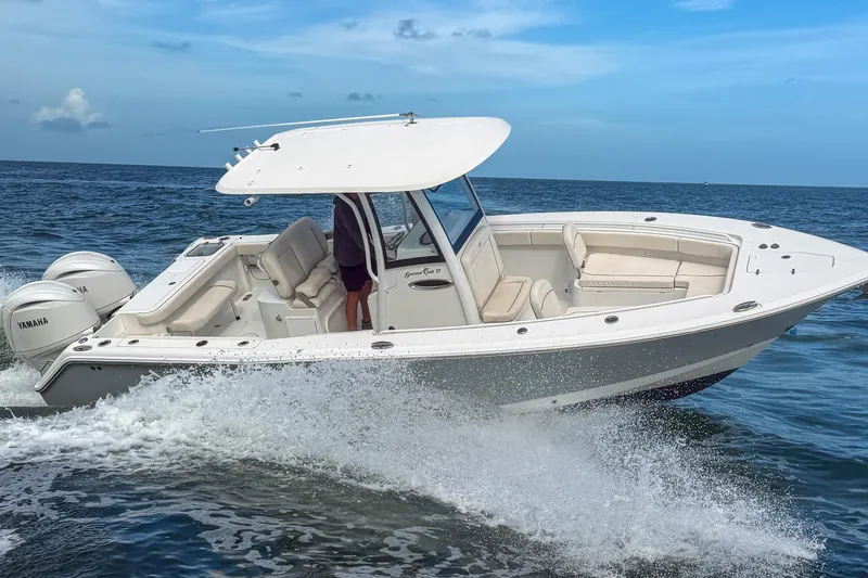 Slide: The Image of 2024 Sea Hunt Gamefish 27 Forward Seating boat cruising on open water. - 8